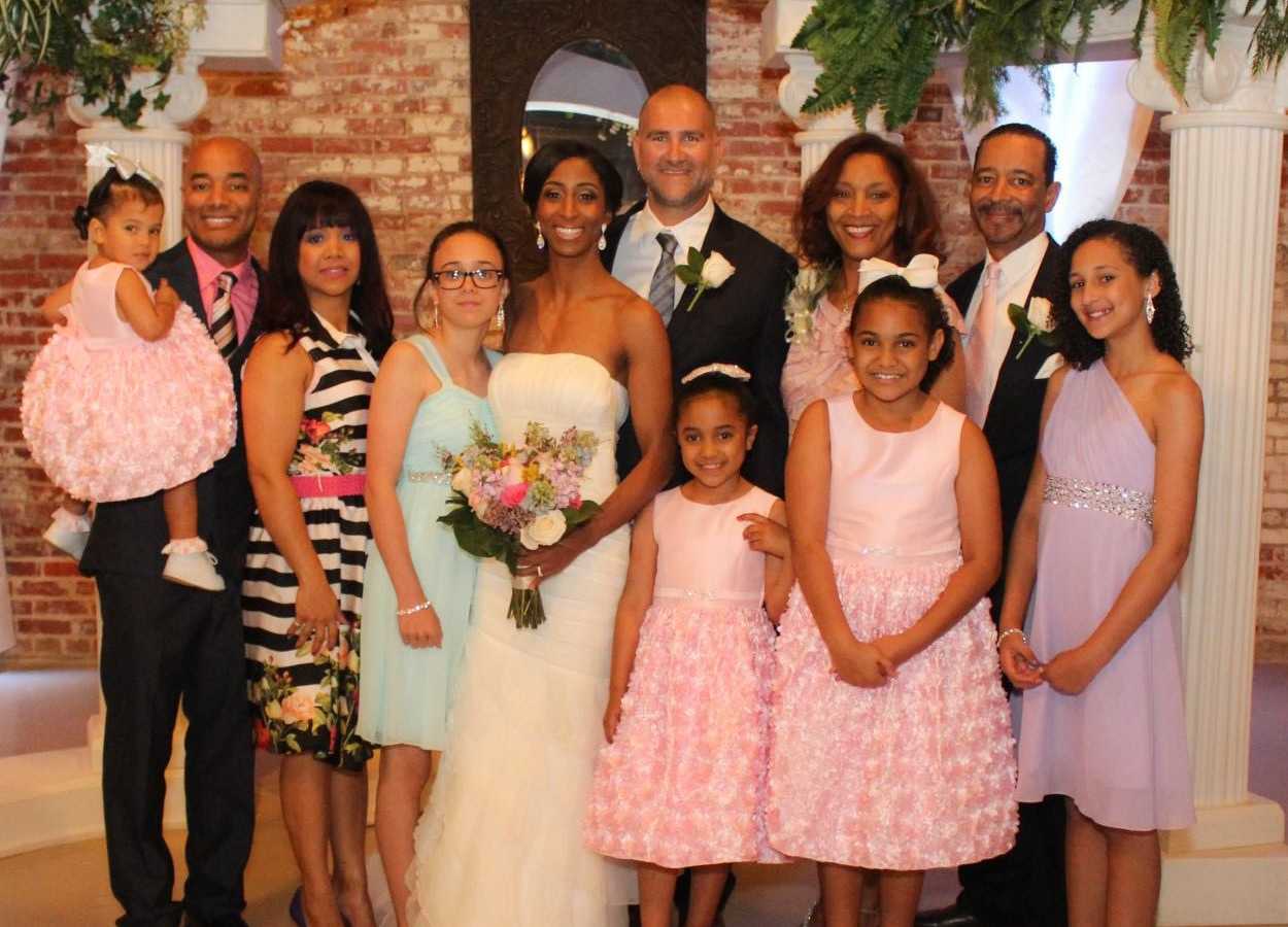 Bride stands beside groom and her side of family