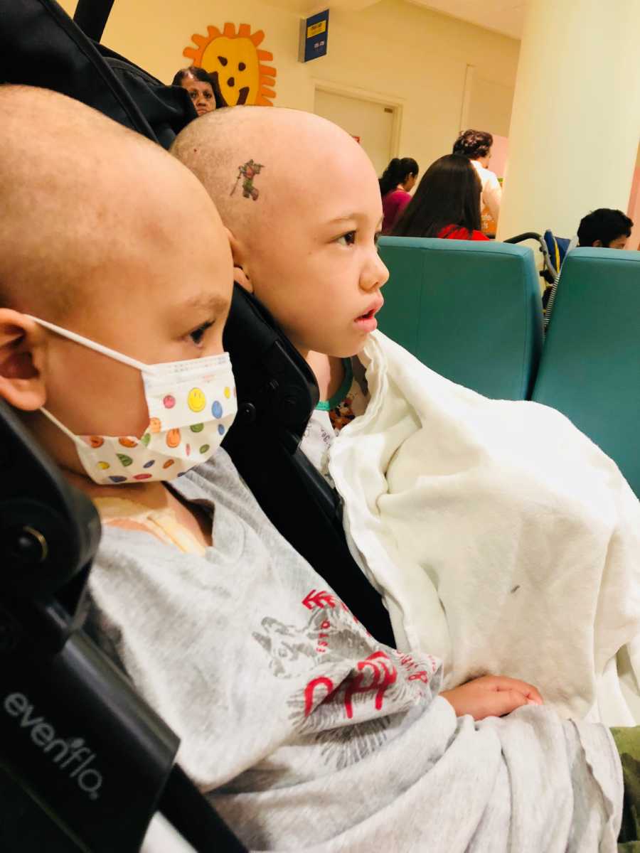 Brother and sister with medulloblastoma sit side by side in stroller