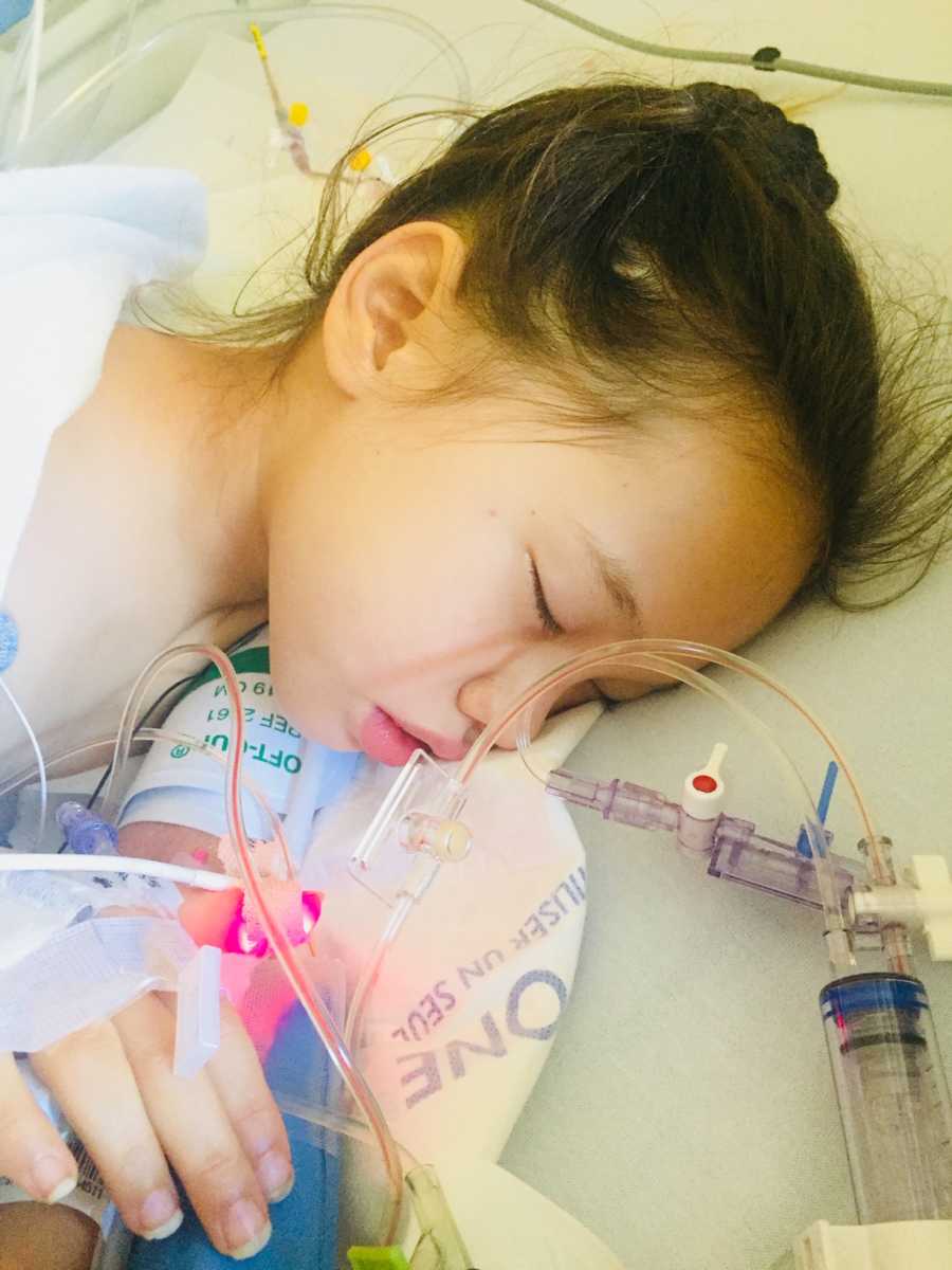Little girl on fourth round of chemo lays asleep in hospital