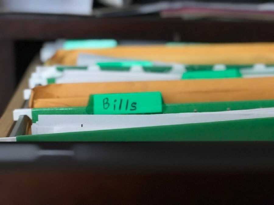 File cabinet zoomed in on folder labeled "bills"