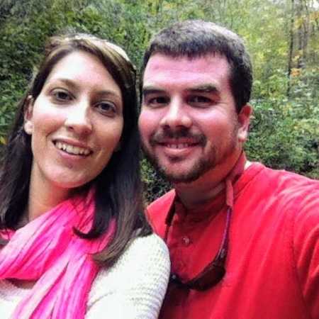 Engaged couple smile in selfie in wooded area
