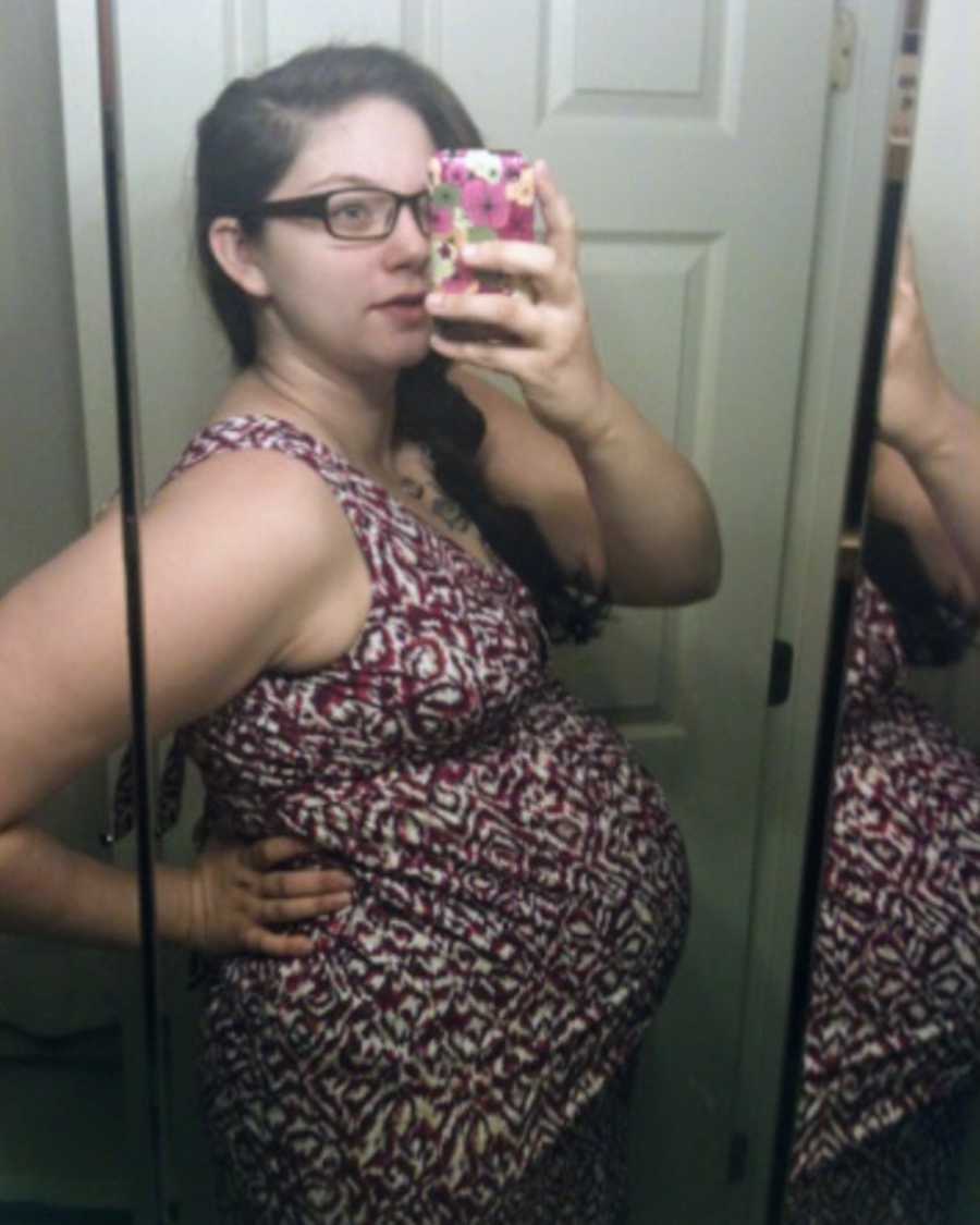 Pregnant woman with twins takes mirror selfie in bathroom