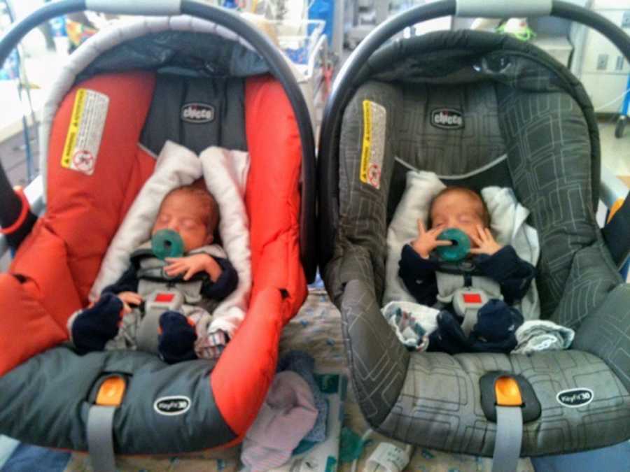 Newborn twins with cerebral palsy sit asleep in car seats