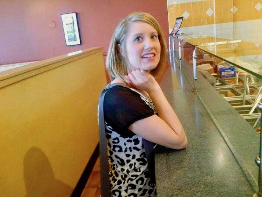 Woman who has since passed from cancer stands smiling at counter ordering food