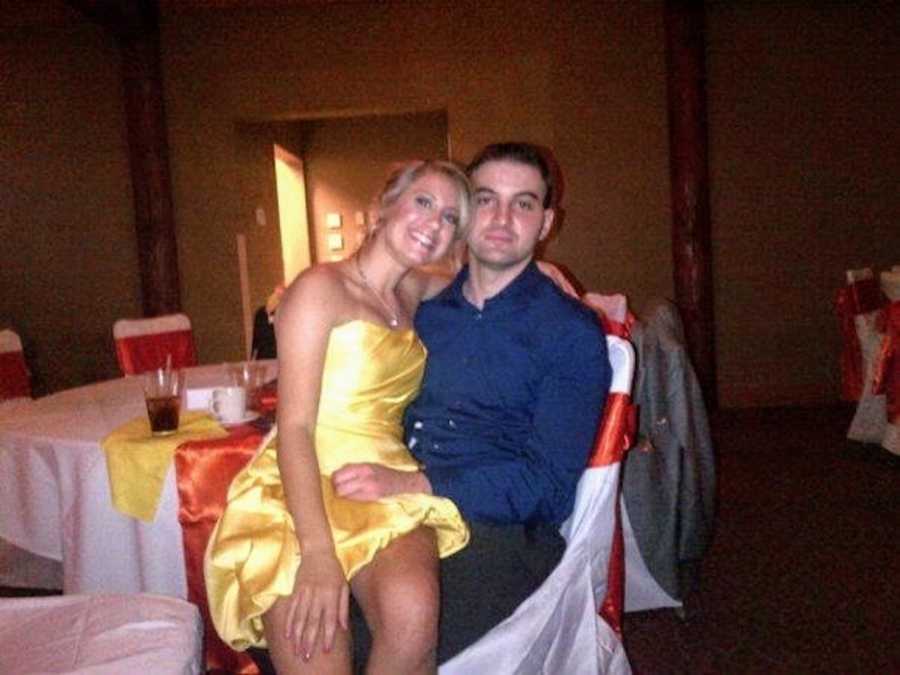 Man sits in chair at formal event with wife who has since passed sitting in his lap