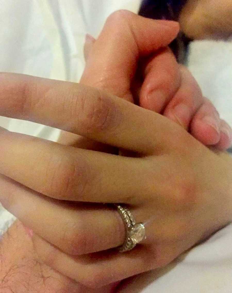 Close up of husband holding wife's hand who has since passed from cancer