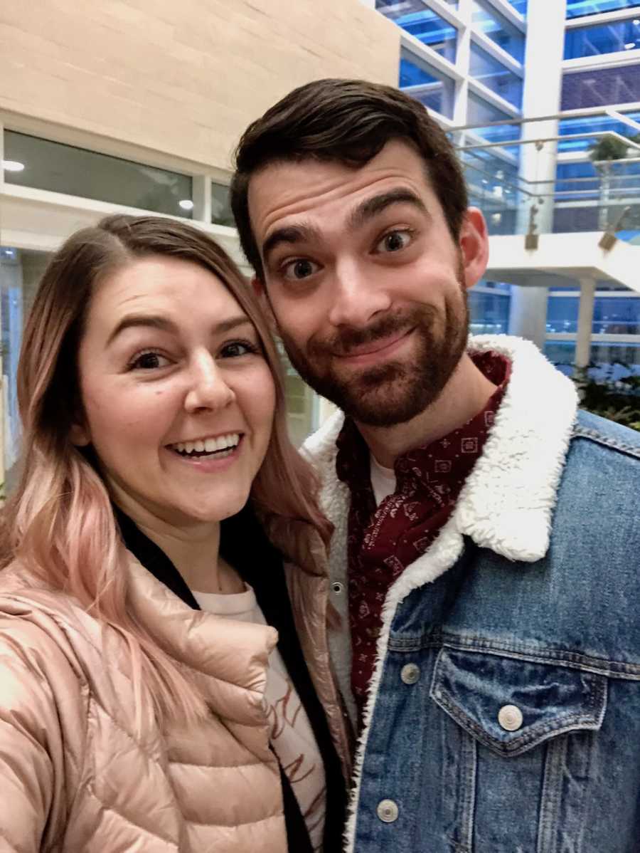 Husband and wife smile in hospital where there adopted child will be born