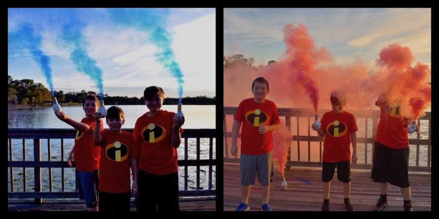 Side by side of three boys wearing Incredibles shirts holding canister of blue and pink powder 