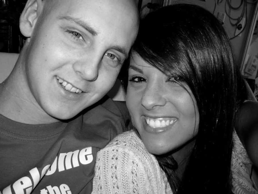 Teen boyfriend with Leukemia sits smiling with girlfriend at his side