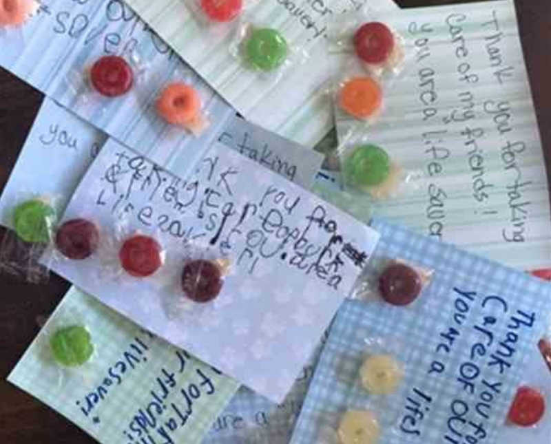 Pile of notecards with packs of Life Saver candy on top of them