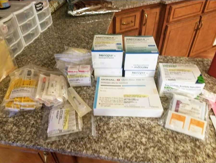 Kitchen counter full of IVF needles and fertility medication