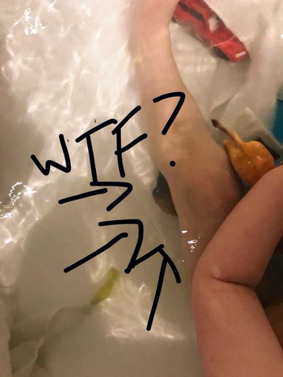 Young kid in bathtub with poop in it and letters "WTF" written over it