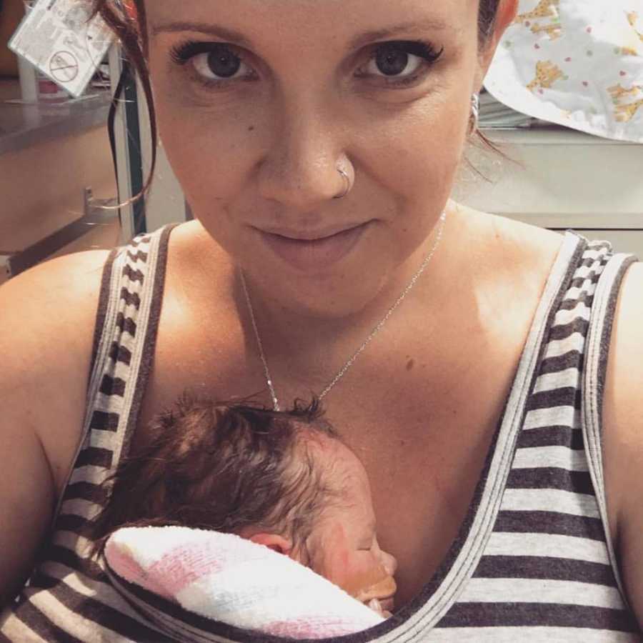 Mother takes selfie as she baby sits asleep inside her shirt