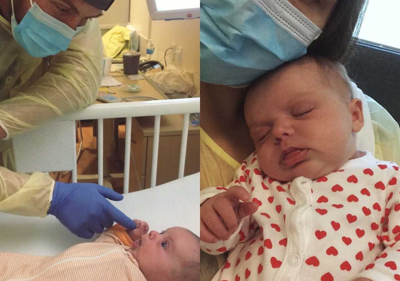 Father stands over baby with Bubble Baby Disease and then she sits on lap of mother