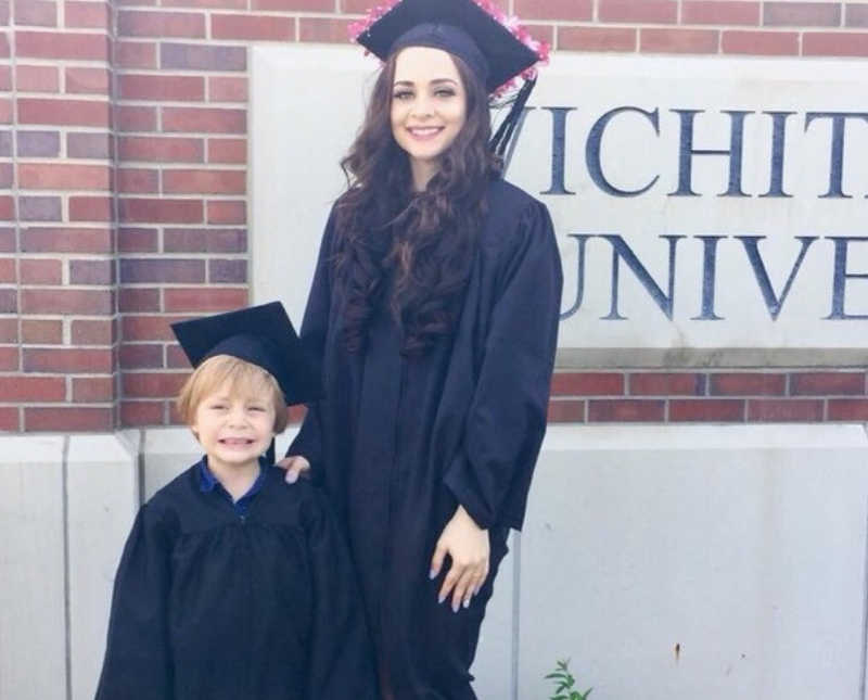 College grad stands in cap and gown with her son beside her in matching cap and gown