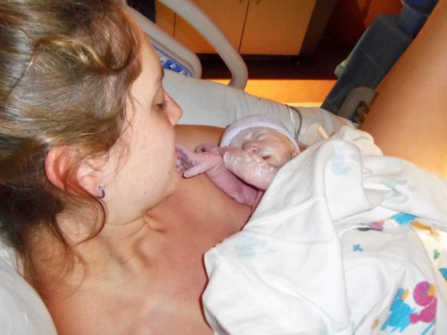 Newborn lays on shirtless mother's chest