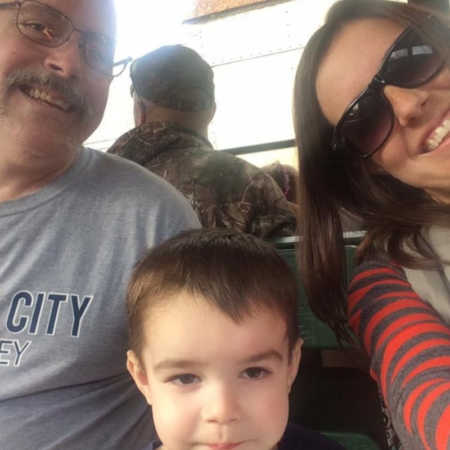 Woman smiles in selfie with son and father who has since passed away from addiction