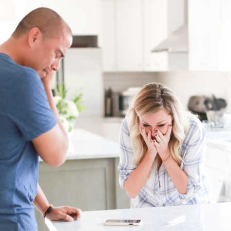 Husband and wife cry in kitchen as they hear they news that they have an egg donor