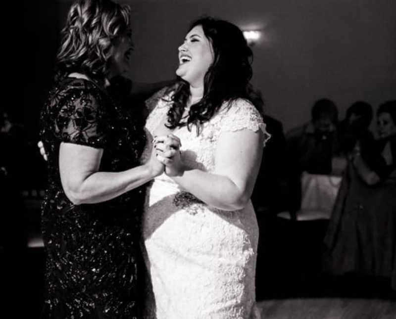 Bride dances with mother at wedding