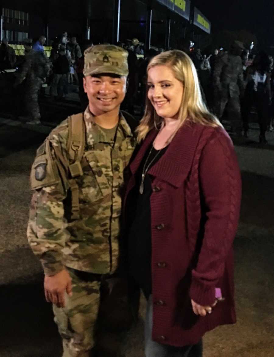 Woman standing beside husband in army who is in uniform