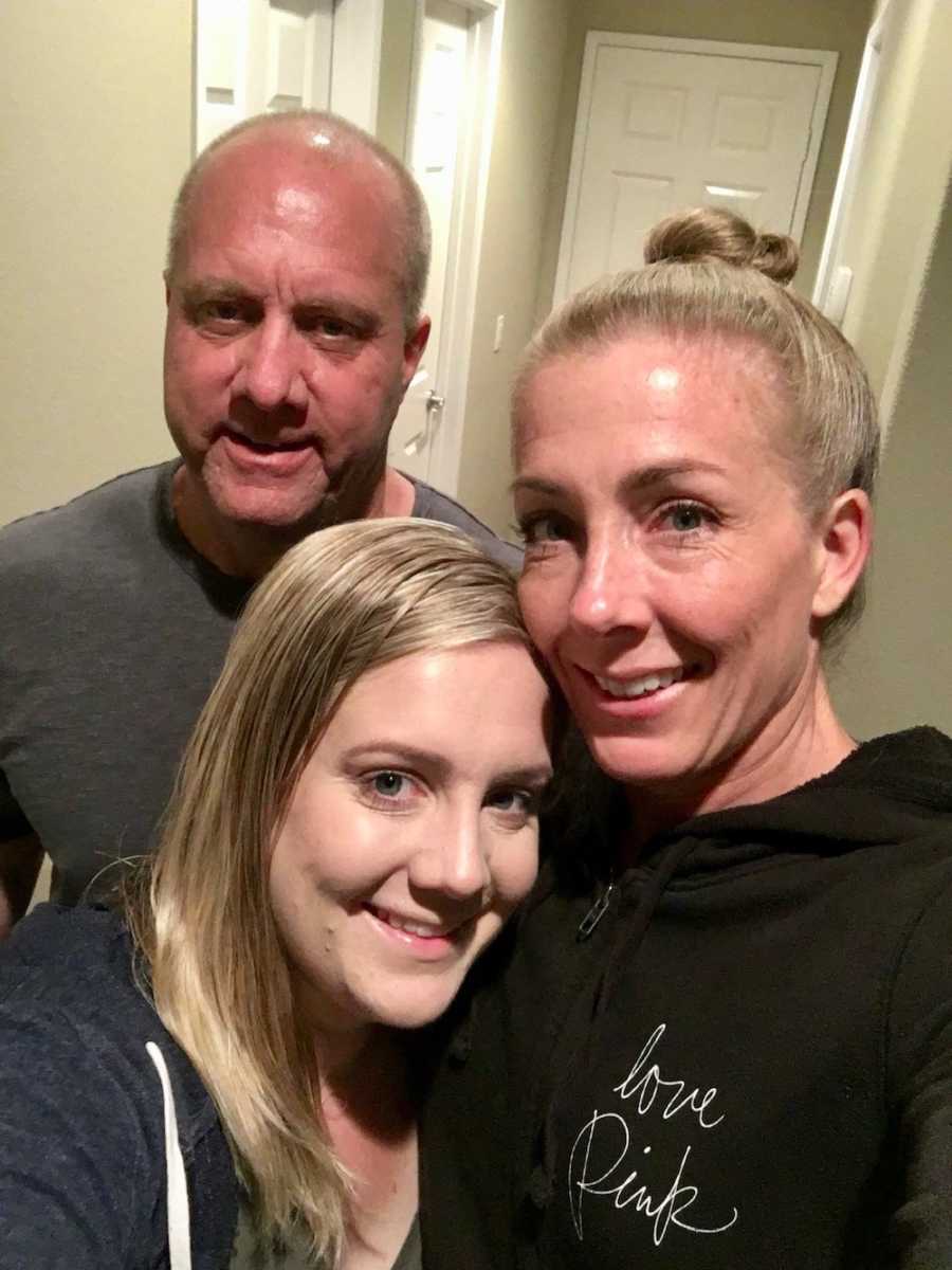 Young woman with Crohn’s Disease smiles in selfie with her parents