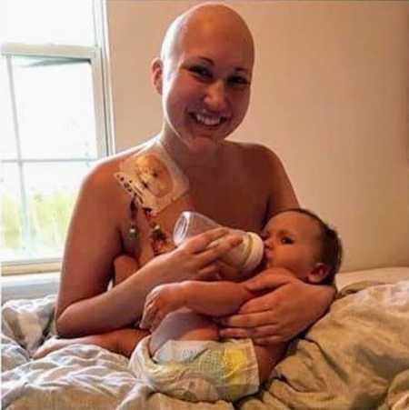 Mother with Acute B-Cell Lymphoblastic Leukemia smiles as she bottle feeds daughter