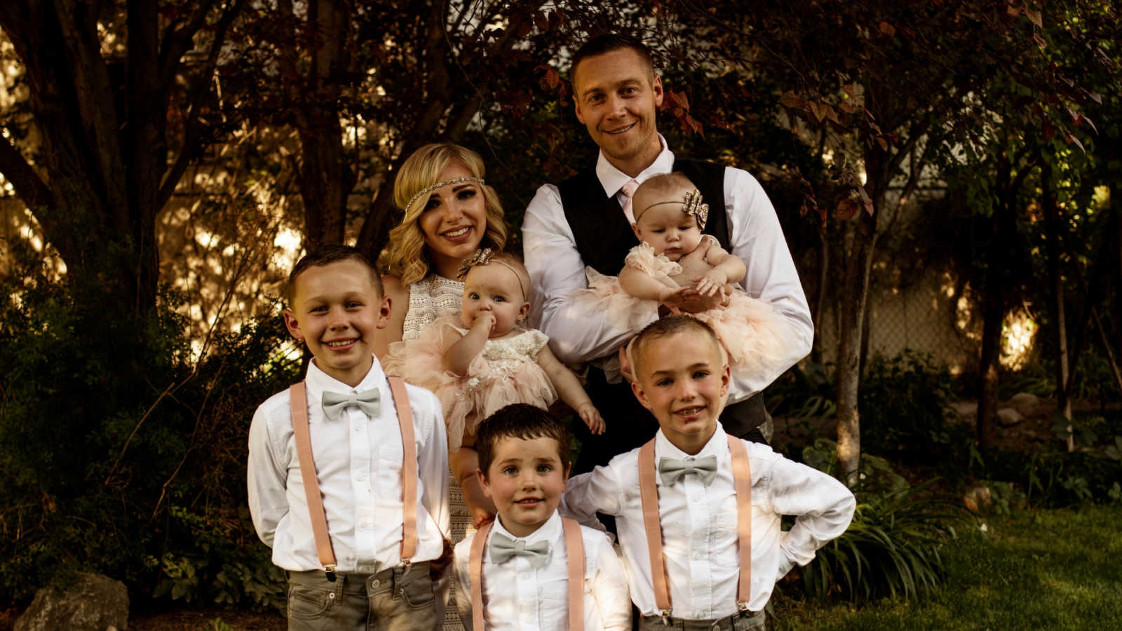 Woman who escaped abusive marriage stands beside new husband and her five kids