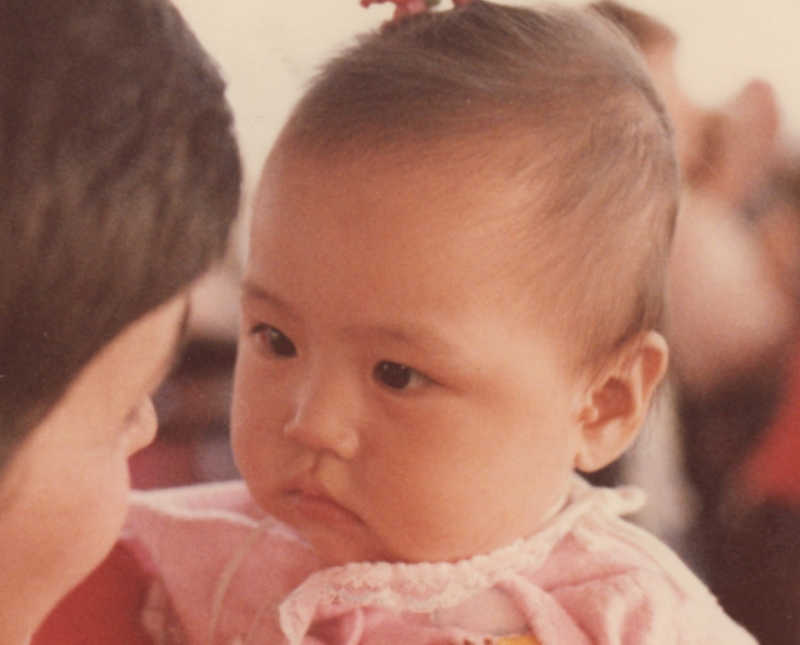 Baby girl looks into eyes of adoptive mother