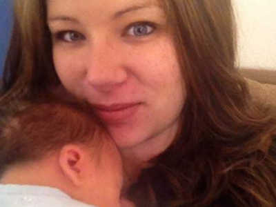 Woman who escaped abusive husband smiles in selfie with baby on her chest