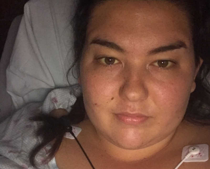 Woman with flu like symptoms takes selfie as she lays in hospital with patches on her chest