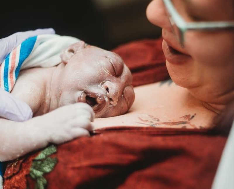Newborn who wasn't suppose to survive lays asleep on mother's chest 