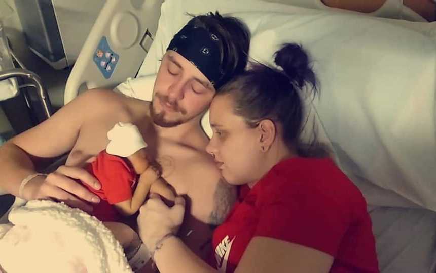 Husband and wife lay in hospital bed with their newborn before she passes away