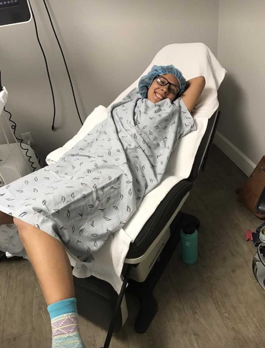 Woman lays in doctor's office fro embryo transfer