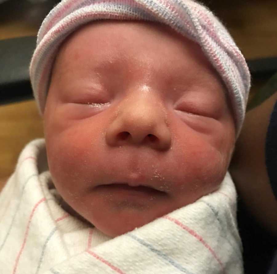 Close up of newborn's face who was delivered after 94 hours of labor