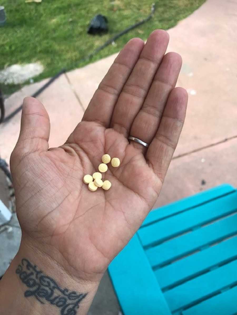 Woman's hand full of IVF pills