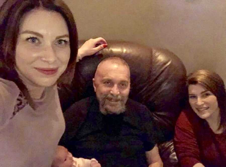 Woman smiles in selfie with father who has brain tumor and her mother