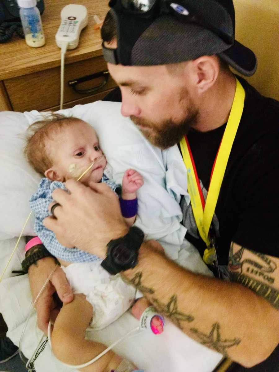 Father holds newborn with unknown disease in his arms