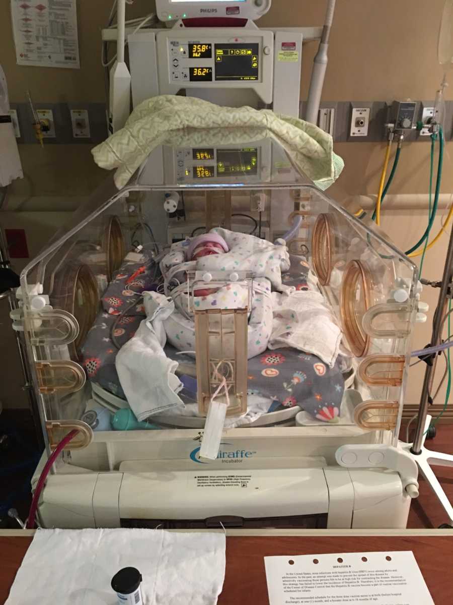Newborn lays in NICU attached to monitors