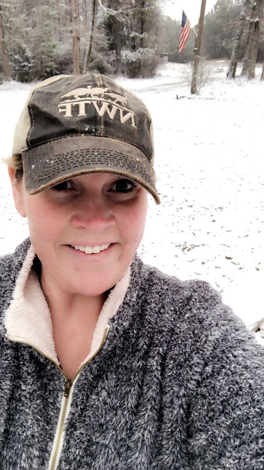 Woman who is now sober smiles in selfie outside in winter weather