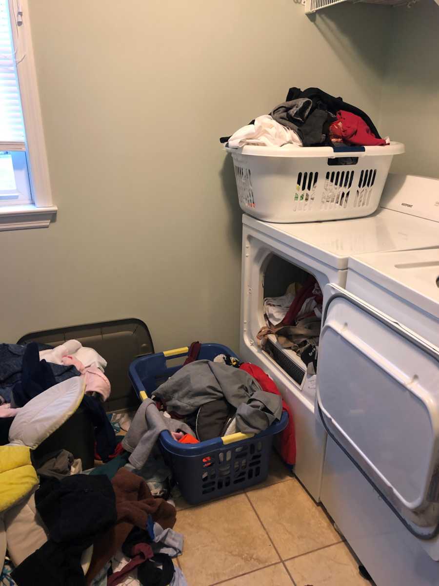 Laundry room with clothes all over 