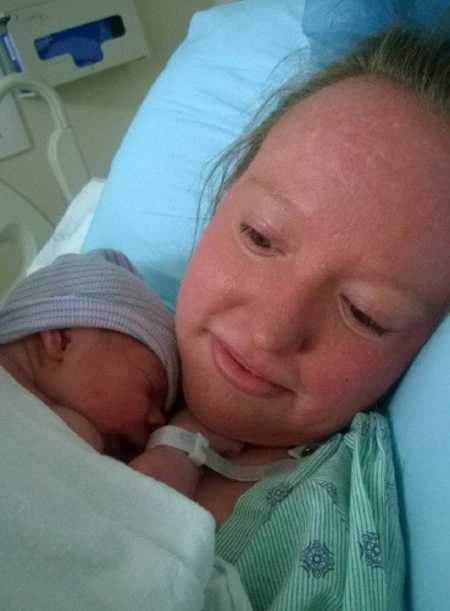 Mother with Ichthyosis lays in hospital bed while newborn lays asleep on her chest