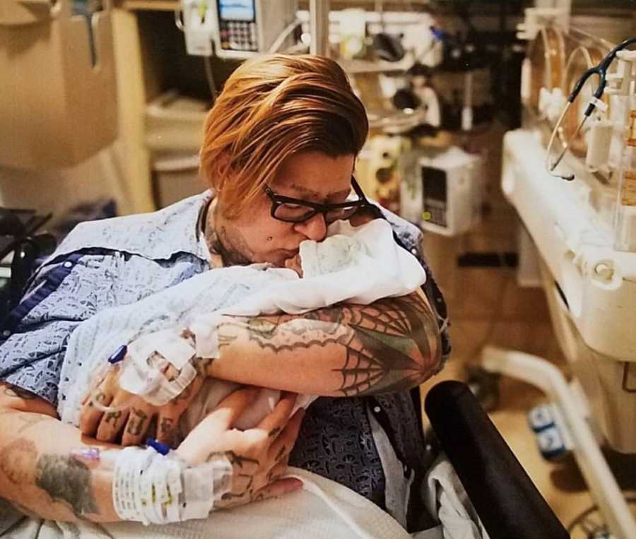 Mother sits in NICU kissing forehead of newborn who will soon pass away