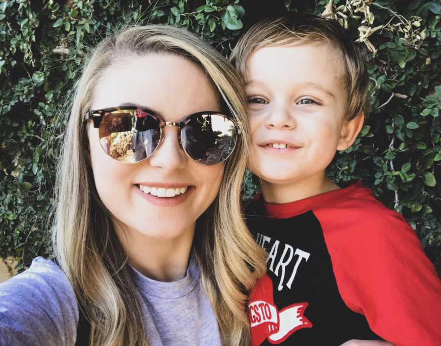 Mother smiles in selfie with her young boy