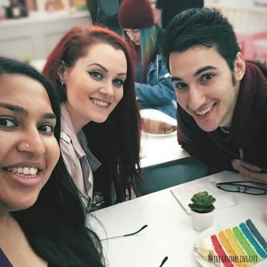 Man with Crohn's disease smiles in selfie beside two of his girl friends who helped him get through it