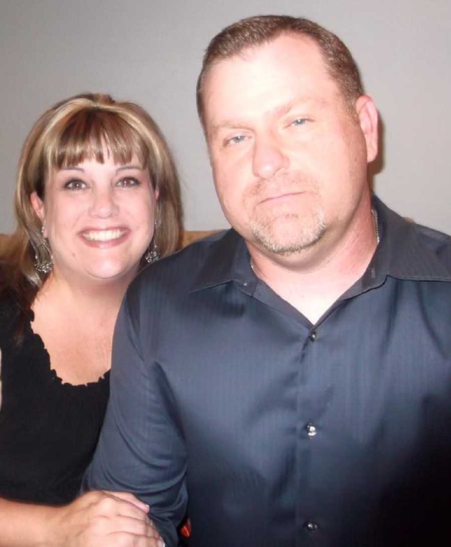 Woman sits smiling beside husband who has since passed