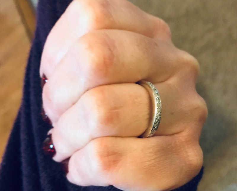 Close up of engagement ring on woman's finger from another woman