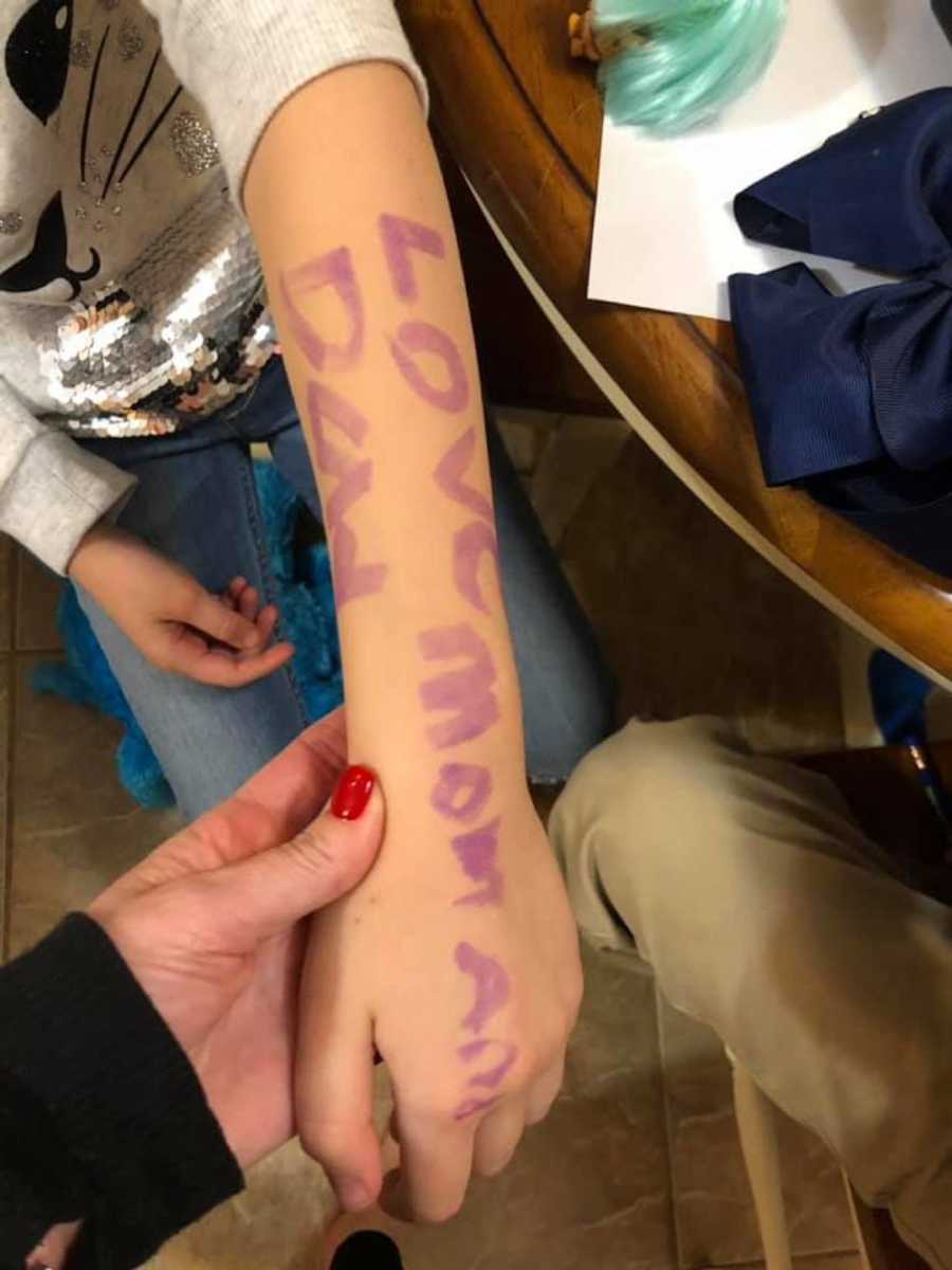 Little girls arm that says "Love mom and dad" after her school had lockdown