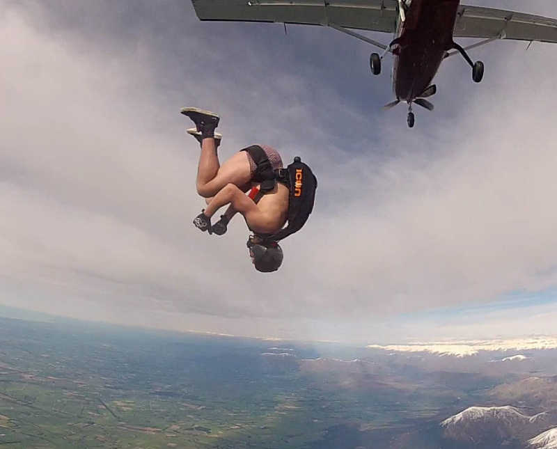 New Zealand track runner does flip as he jumps out of plane
