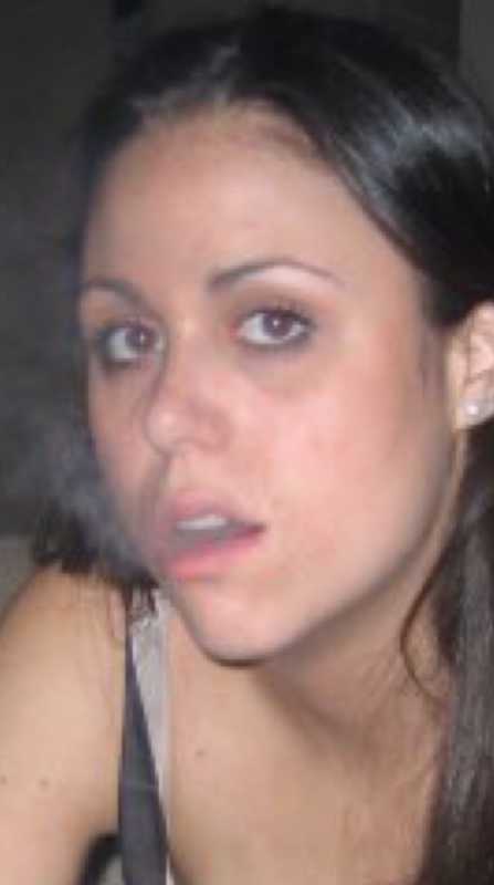 Depressed young woman blows smoke out of her mouth