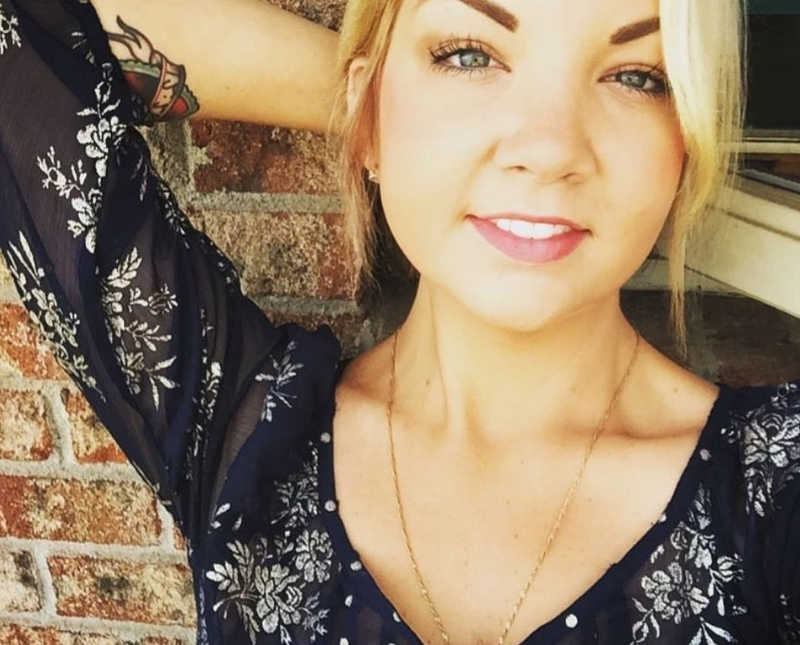 Woman who passed away from addiction to fentanyl smiles with hand behind her head in selfie